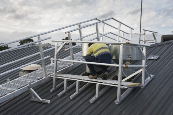 Defender™ walkway leveled on incline roof